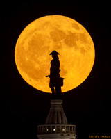 Full Strawberry Moon rising over the William  Penn Statue