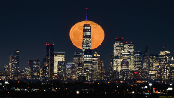 Moon rising over One World Trade Center