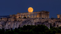 Almost-full Sturgeon Moon rising over the Parthenon on the Acropolis of Athens, Greece