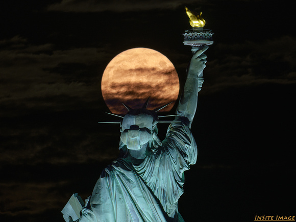 July's Full Buck Moon Rising over the Statue of Liberty