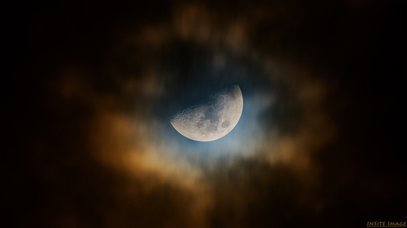 56.8% Waxing Gibbous Moon Shining through the Clouds